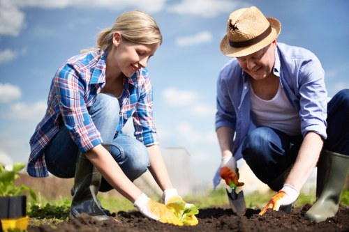 Gardener discussing a complaint with a customer in a garden setting